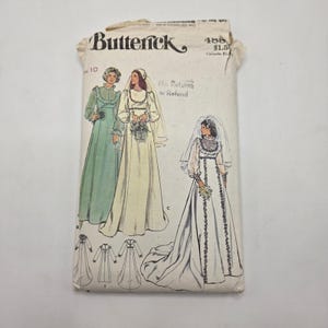 May include: A Butterick sewing pattern envelope, size 10, featuring illustrations of three long dresses with veils. The white paper envelope displays the brand name, pattern number 488, and line drawings of the garment designs at the bottom.