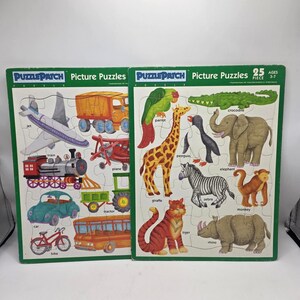 Peut inclure: Deux puzzles pour enfants avec des illustrations colorées. L'un présente des véhicules comme un avion, un train et une voiture. L'autre présente des animaux comme une girafe, un zèbre et un éléphant. Chaque puzzle a 25 pièces.