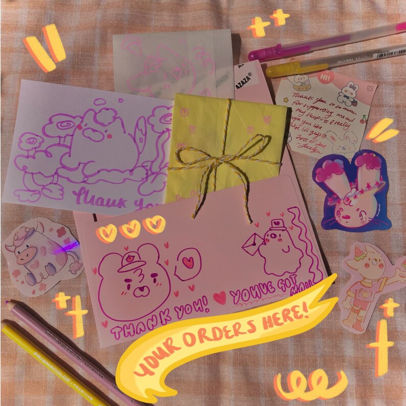 May include: A collection of handmade cards and stickers with cute illustrations and handwritten messages. The cards feature drawings of animals and the text "Thank You!" and "You've Got Mail". A yellow package tied with twine is also included.