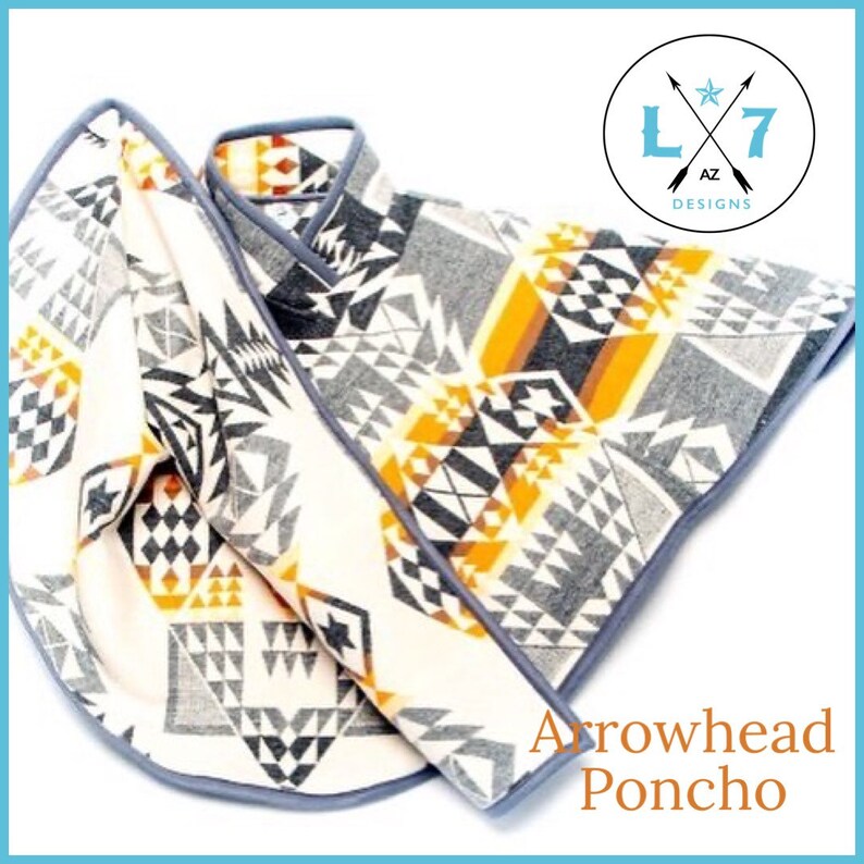 May include: A white, grey and orange patterned poncho with a grey trim. The poncho is folded in half and the text "Arrowhead Poncho" is visible below. The logo "L7 AZ Designs" is in the top right corner.