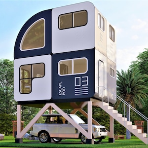 May include: A white and black modular home with a curved roof and windows. The home is elevated on wooden stilts and has a set of stairs leading up to the entrance. The home is labeled "ESCAPE POD".