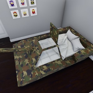 May include: Camouflage-patterned bed shaped like a tank with a white mattress and pillows. The bed has a raised section at the head and a cannon on the front.