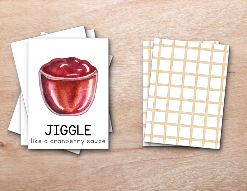 K&ouml;nnte beinhalten: Eine wei&szlig;e Karte mit roter Cranberry-Sauce in einer Glassch&uuml;ssel. Die Karte sagt "JIGGLE like a cranberry sauce".