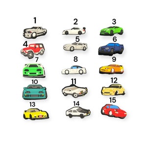 May include: A set of 15 colorful car shoe charms, featuring different car models in various colors, including red, blue, green, yellow, and white. The charms are numbered 1 through 15.