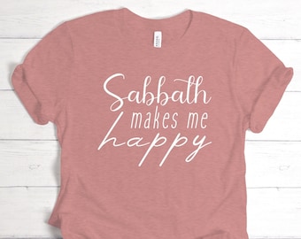 May include: A pink t-shirt with the text "Sabbath makes me happy" in white cursive lettering.