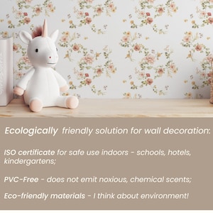 May include: A white unicorn plush toy sits on a shelf with a floral wallpaper background. The shelf also has a stack of books and a woven basket with a white bottle inside. The text below the shelf reads "Ecologically friendly solution for wall decoration: ISO certificate for safe use indoors - schools, hotels, kindergartens; PVC-Free - does not emit noxious, chemical scents; Eco-friendly materials - I think about environment!"