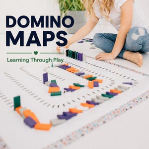 May include: A white play mat featuring black printed paths and lines for arranging dominoes, labeled DOMINO MAPS Learning Through Play. The mat is covered with colorful orange, purple, green, and grey dominoes set up in various patterns.