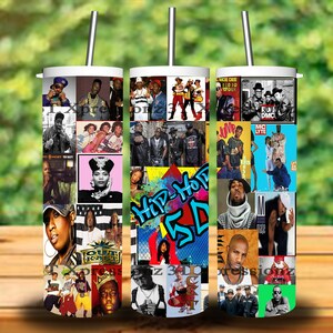 May include: Three white tumblers with lids and straws feature a collage of hip hop artists and album covers from the 1990s. The tumblers are on a wooden surface with a green background.