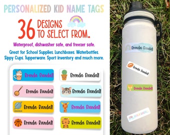 May include: A set of 36 colorful personalized name tags with various designs, including a basketball, a cactus, a giraffe, a cat, a rocket, and a rainbow. The name tags are waterproof, dishwasher safe, and freezer safe. The text on the name tags reads "Brenda Randall".