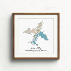 May include: A framed print with a map of Barcelona, Spain, shaped like an airplane. The text "Scot & Ashley" and "The best memories are the ones we make together" is printed below the map.