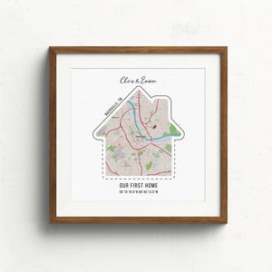 May include: A framed print with a map of Nashville, Tennessee, shaped like a house. The text "Chris & Ember" and "Our First Home" is printed below the map.