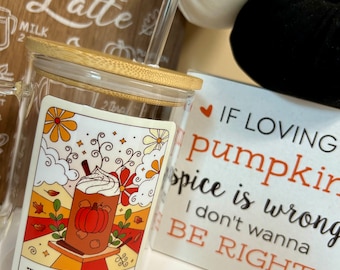 May include: A glass mug with a bamboo lid and a straw. The mug has a graphic of a pumpkin spice latte with fall leaves and the text "The Pumpkin Spice". The mug is next to a white sign with the text "If loving pumpkin spice is wrong I don't wanna be right."