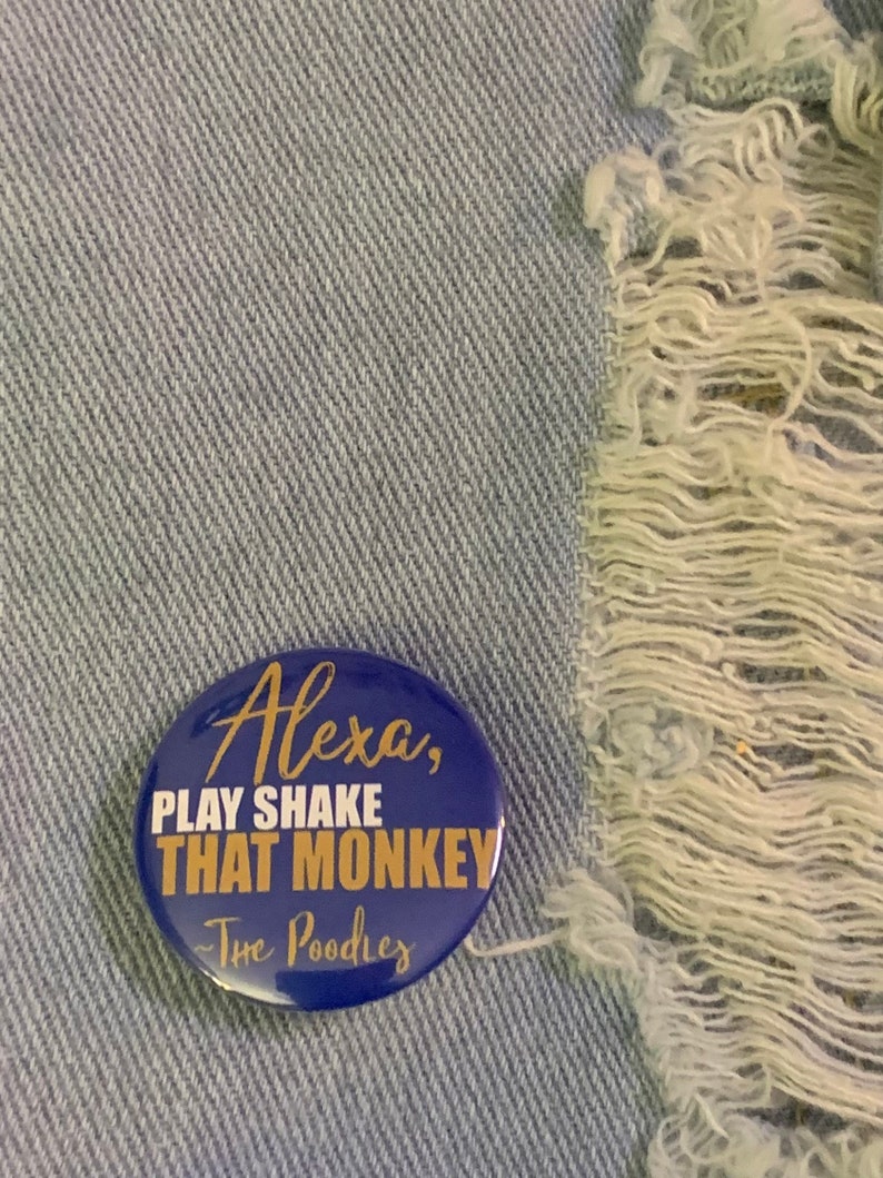 May include: A blue button with gold text that reads "Alexa, Play Shake That Monkey - The Poodles".