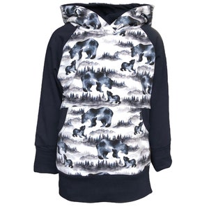 May include: A navy blue hooded sweatshirt with a white and gray pattern of bears and trees. The sweatshirt has a kangaroo pocket and raglan sleeves.