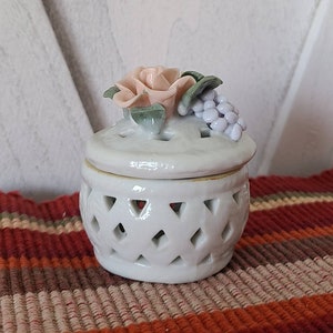 Vintage trinket dish with rose decoration on the lid.