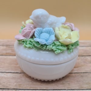 Vintage trinket dish with rose decoration on the lid.