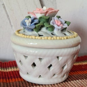 Vintage trinket dish with rose decoration on the lid.