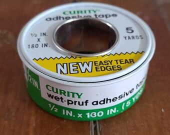 May include: A roll of white adhesive tape with green and yellow accents. The tape is labeled "CURITY wet-pruf adhesive tape 1/2 IN. x 180 IN. (5 YARDS) NEW EASY TEAR EDGES".