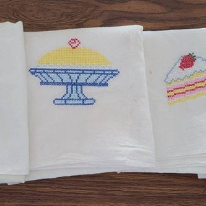 Set of 4 tea towels with cute cross-stitch on each.