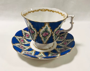 May include: A blue and white teacup and saucer set with a floral pattern and gold trim.