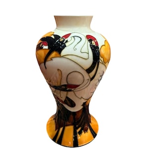 May include: A white ceramic vase with a yellow, orange, black and red design of stylised birds. The vase has a wide mouth and a narrow base.