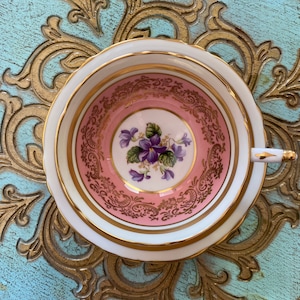 Unique paragon pink tea cup and saucer with purple violets flowers, English bone china collectible