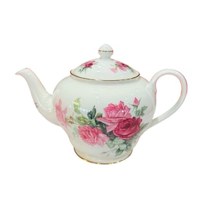 May include: White porcelain teapot with a lid, featuring a floral rose design in shades of pink and green. The teapot has a curved spout, a rounded handle, and gold trim. A classic tea party item.
