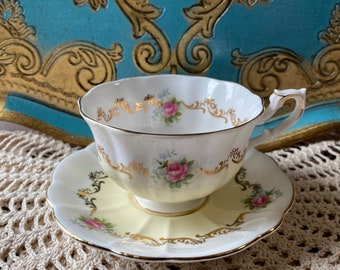 Vintage royal Albert invitation series tea cup and saucer yellow with little pink roses and gold details, English bone china