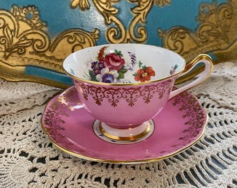 Collectible vintage hot pink exterior royal Albert tea cup and saucer with pink floral pattern, English bone china. Gift for her