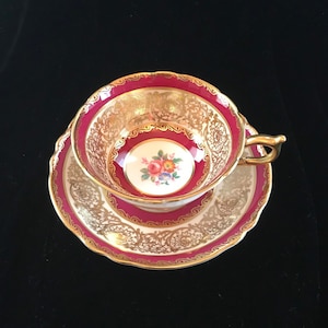Beautiful double warrant red and gold Paragon tea cup and saucer with floral center, English bone china gift
