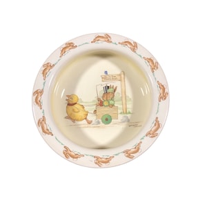 May include: A white ceramic bowl with a green rim and a border of brown bunnies. The bowl features a Beatrix Potter illustration of a rabbit pulling a cart with a duckling. The sign reads "To The Hunt Ball".