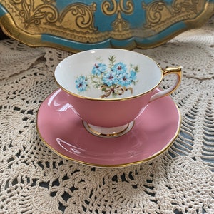 Vintage aynsley pink exterior tea cup and saucer with blue flowers and bow tie, bone china aynsley