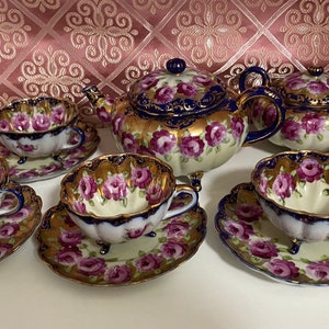 Rare set of Handpainted 3-legged blue unmarked (probably Nippon Japan) tea set for four, pink roses, teapot cream sugar, cups and saucers
