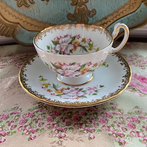 Vintage aynsley oban shaped tea cup and saucer with white orchids and gold details