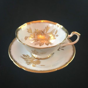 Paragon tea cup and saucer gold rose on pale blue background, widemouth paragon tea set with gold trim
