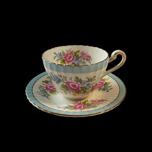Paragon tea cup and saucer with baby blue border and pink roses, collectible English bone china