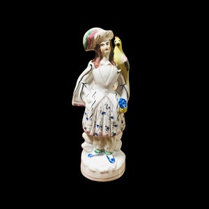 As is 19th century Antique Staffordshire English porcelain figurine 10’5” T a man with a parrot , collectible Antique figurine.