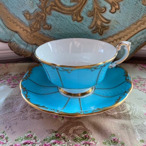 Paragon sky blue tea cup and saucer with labels gold border, English bone china