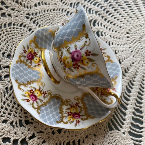 Rare royal Albert Marie louise Gray and shops gold tea cup and saucer, Avon shape, gold bow tie Garland, pink roses