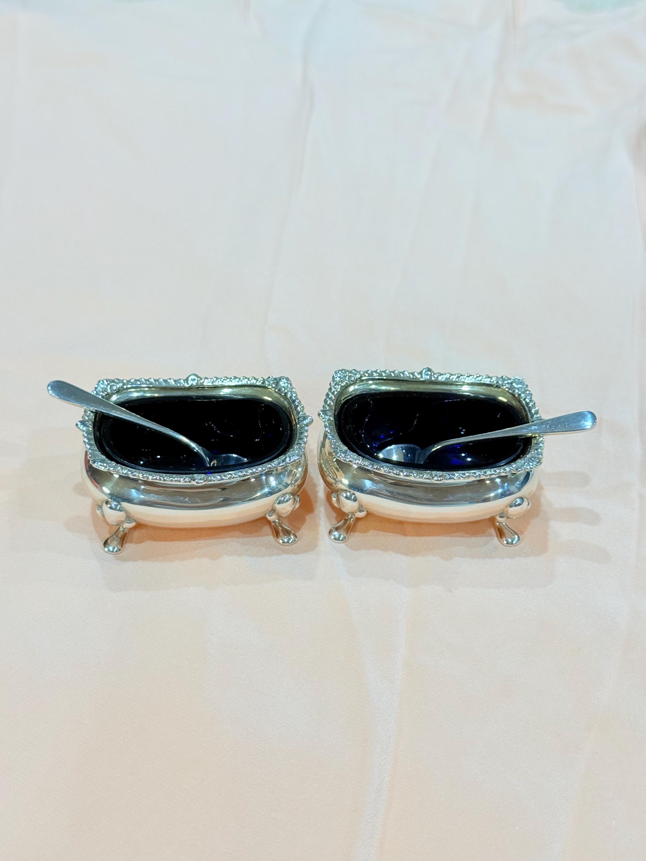 A pair Hallmarked Birmingham Sterling Silver 1921 Salt Cellars with Cobalt Blue glasses and spoons .