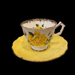 Vintage crocus shaped aynsley tea cup and saucer with large yellow cabbage rose and gold details