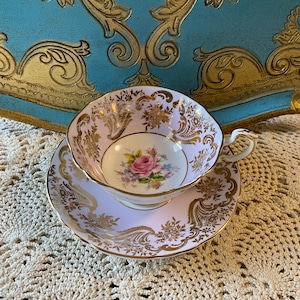 Rare purple double warrant paragon tea cup and saucer with pink rose centre and gold details, collectible bone china