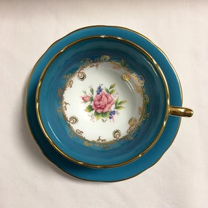 Turquoise aynsley tea cup and saucer with pink rose Centre