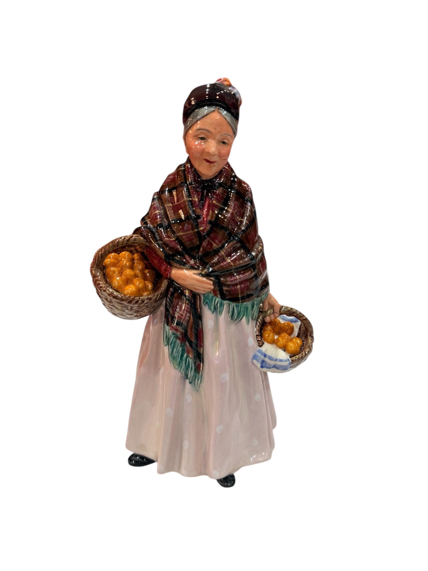 Royal Doulton Figurine “ The Orange Lady” HN 1759 made in England 8 1/2” T , great condition.