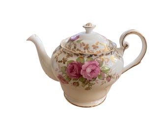 May include: A white porcelain teapot with a floral design featuring pink roses and gold accents. The teapot has a lid and a spout.