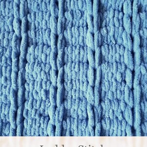 Puede incluir: Primer plano de una tela de punto azul con un patr&oacute;n de punto de escalera. La tela es suave y esponjosa, y el punto crea un aspecto texturizado.