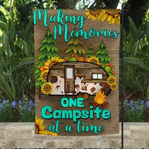May include: A brown burlap garden flag featuring a vintage camper, sunflowers, and trees. The text reads "Making Memories One Campsite at a time".