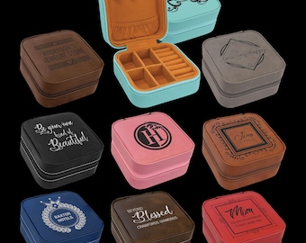 May include: Nine different square-shaped jewelry boxes with various colors and designs. The boxes are made of faux leather and have a zipper closure. Each box has a different inscription on the top, including "Anderson's Jewelry Store", "Love Joy Happy", "Be Your Own Kind of Beautiful", "H", "Jenna", "Baxter Hotels", "Beyond Blessed Crawford Diamonds", and "Mom".