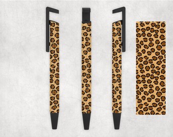 May include: Three black pens with a leopard print design. The pens have a clip on the top and a black cap.