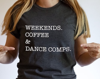 May include: A dark gray t-shirt with white text that reads "Weekends. Coffee & Dance Comps."